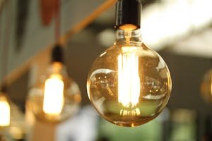 A close-up of a glowing vintage Edison bulb creating a warm atmosphere.