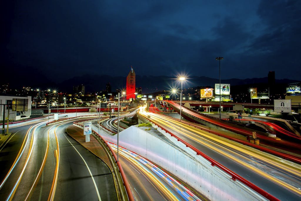 Captivating night view showcasing light trails on a bustling highway in Monterrey, Mexico.